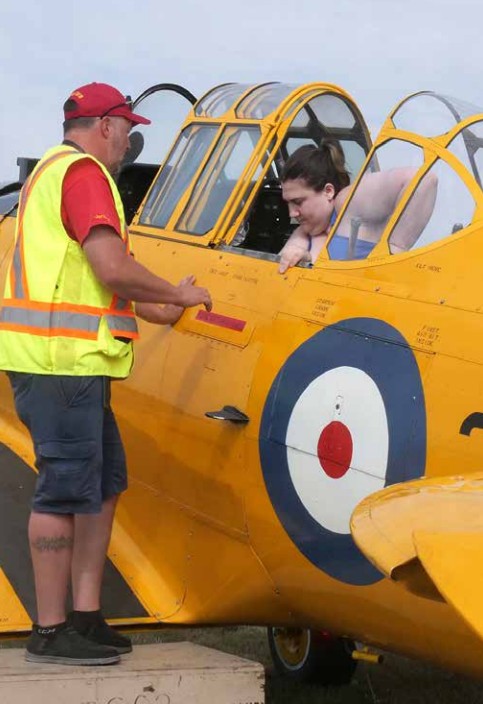 Canadian Harvard Aircraft Association volunteer Jeremy Williams provides pre-flight instructions to Amanda Fluhrer in a Yale on Sept. 13. CHAA’s next open house and fly day at the Tillsonburg Regional Airport is Oct. 4.