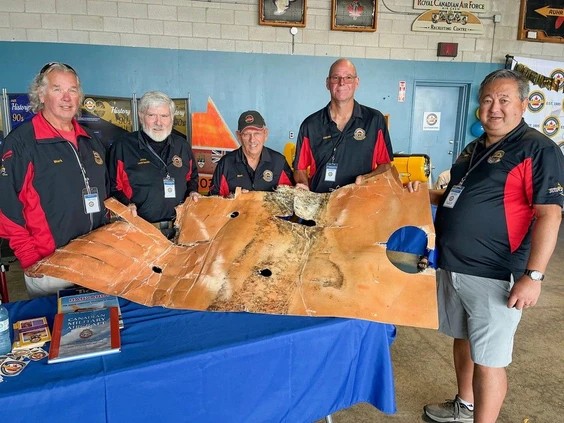 Mark Phillips, John Bowlby, Mark McRae, Darren Nyp and Walther Irie, members of the Canadian Harvard Aircraft Association Dive Team with a recovered wing fuel tank liner from a P51D Mustang that crashed June 10, 1952 and was recovered by the team on June 18, 2023. Missing from the photo is Paul Chappel. The wing fuel tank liner is one of many items the team had on display at the annual Wings and Wheels Fun Day held by the association at the Tillsonburg Regional Airport on Saturday. Photo by Vincent Ball /Vincent Ball/The Expositor