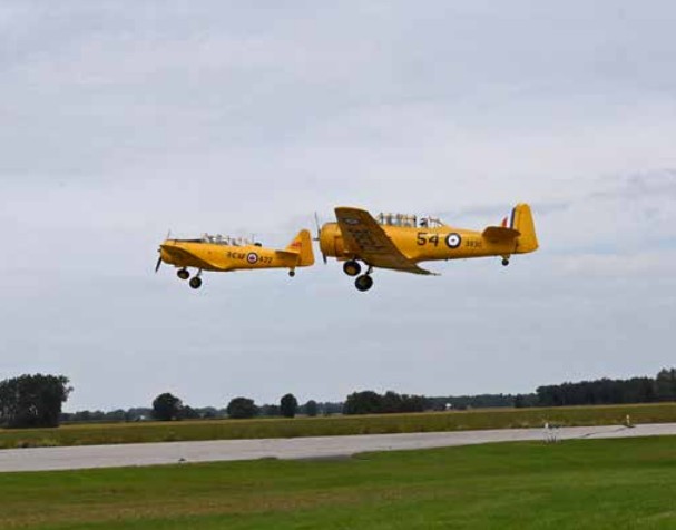 Two planes flying formation provided a thrill for Wings and Wheels attendees after the planes took off together, flew side by side, and then flew over with smoke trails behind. (JEFF HELSDON PHOTO)
